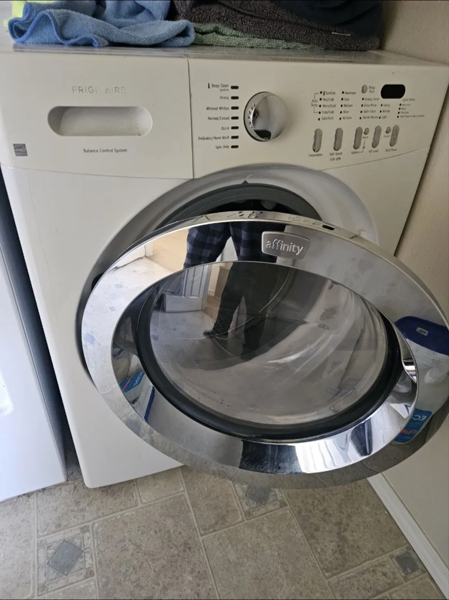 A white Frigidaire Affinity front-loading washer with its door open