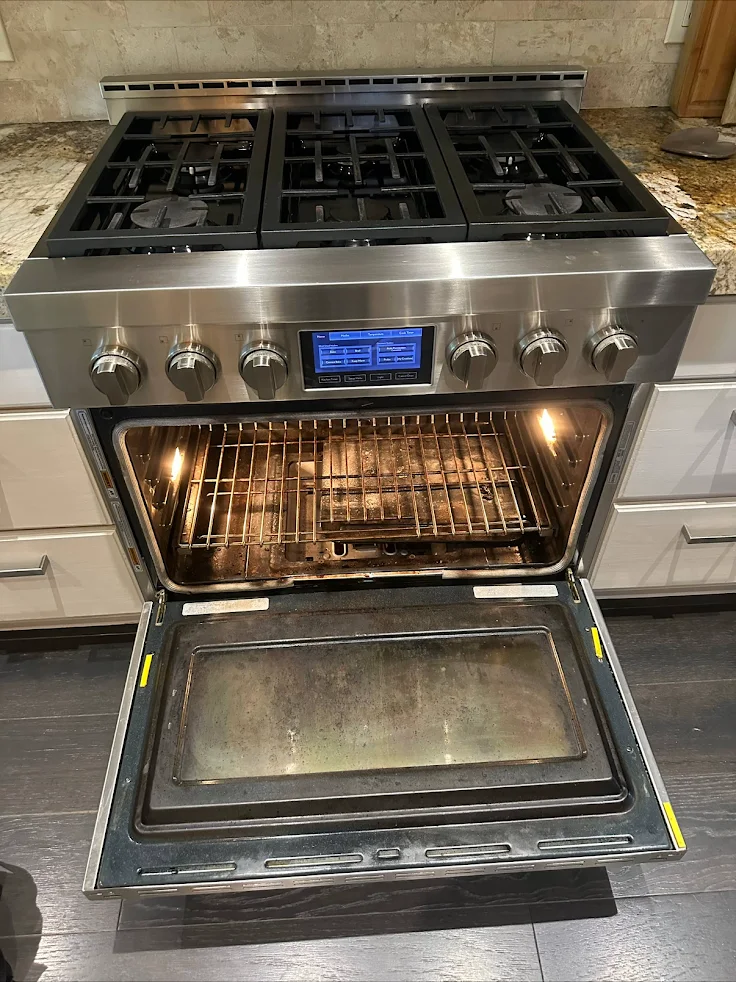A gas range and open oven in an Oasis company-uploaded photo